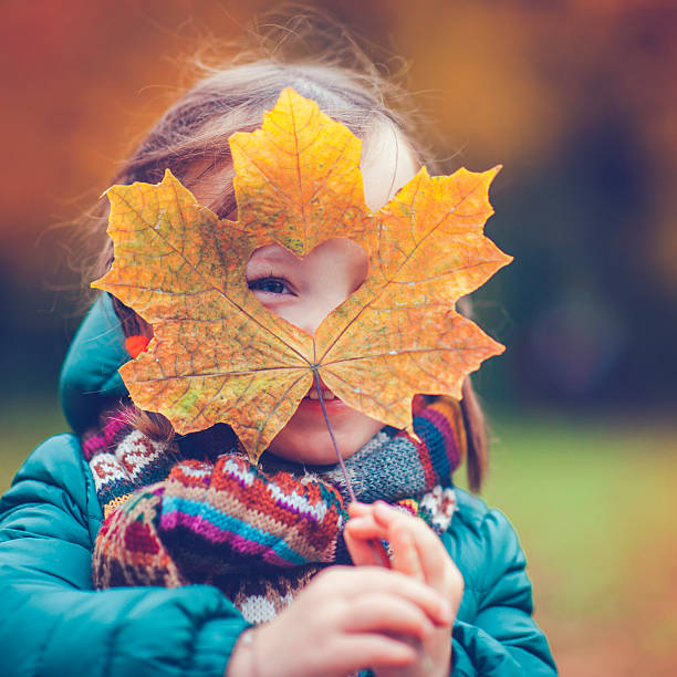 istock Little girl in autumn park 608005362