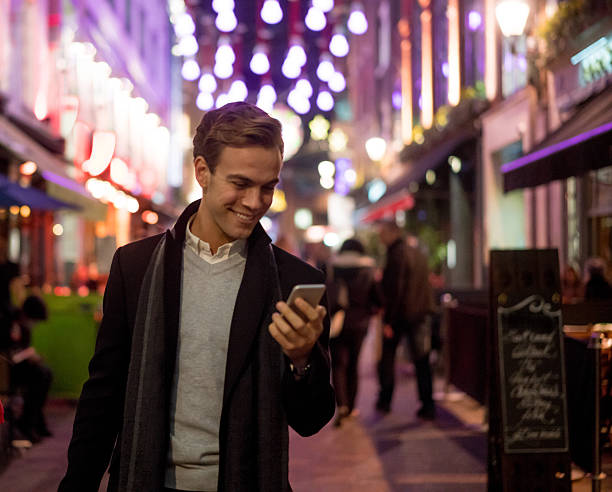istock Shopping man texting on his phone 608005706