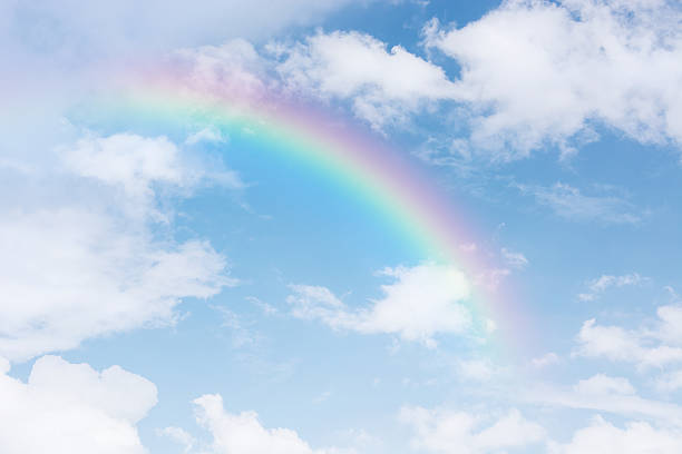 istock rainbow across in the blue sky after the rain 608006196