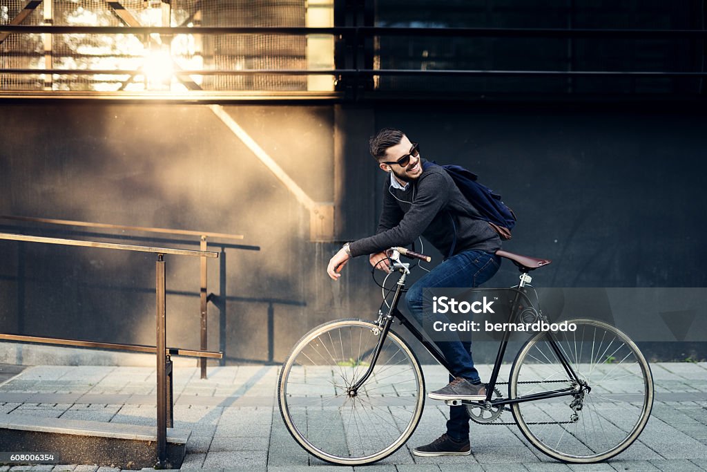 Best city transportation A young stylish businessman going to work by bike. Cycling Stock Photo