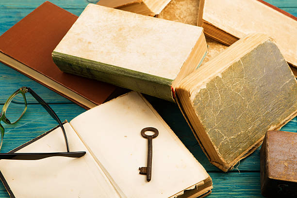istock Old keys on old book and stack of antique books 608007044