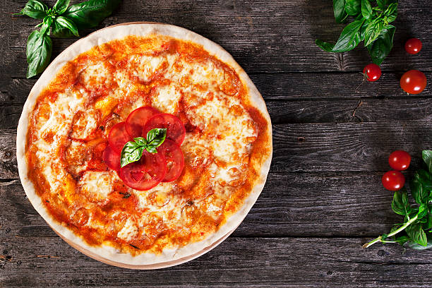 istock Margharita Pizza on the wooden. Top view. 608007870
