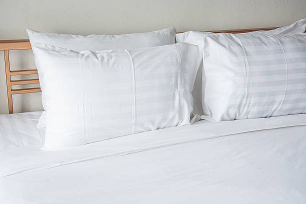 istock white pillow on bed with white blanket in bedroom 608010564