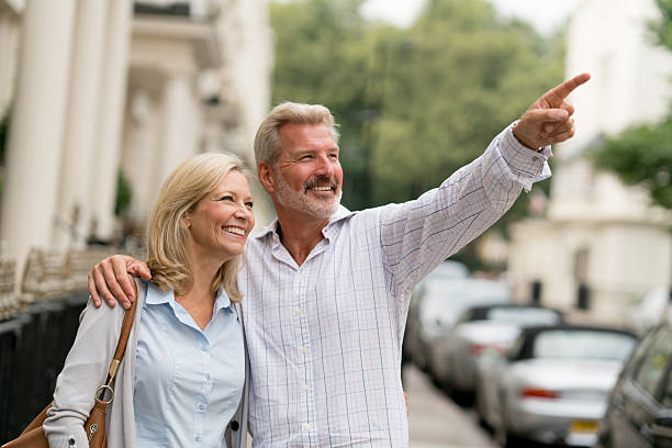 istock Happy couple looking at houses 608481854