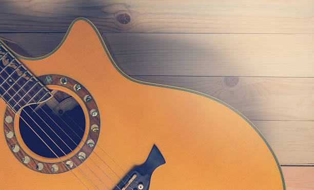 istock Half section of acoustic guitar on wood with copy space 608482362