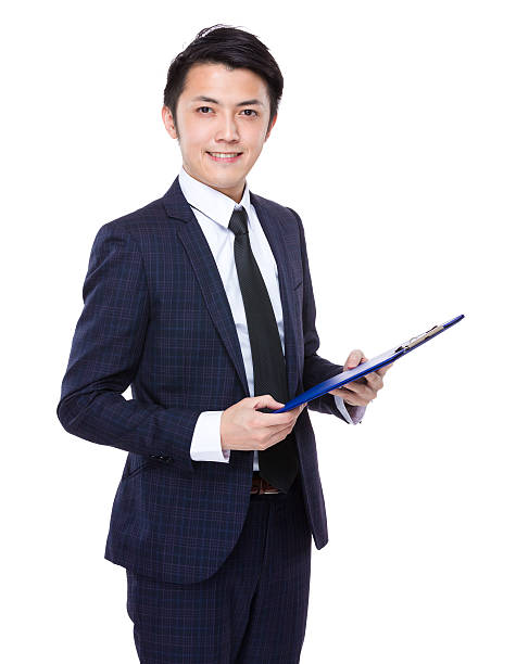 istock Businessman holding a clipboard 608483610