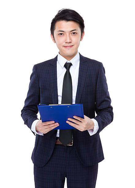istock Businessman holding a clipboard 608485478
