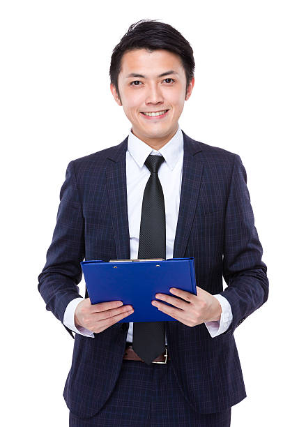 istock Businessman holding a clipboard 608487040