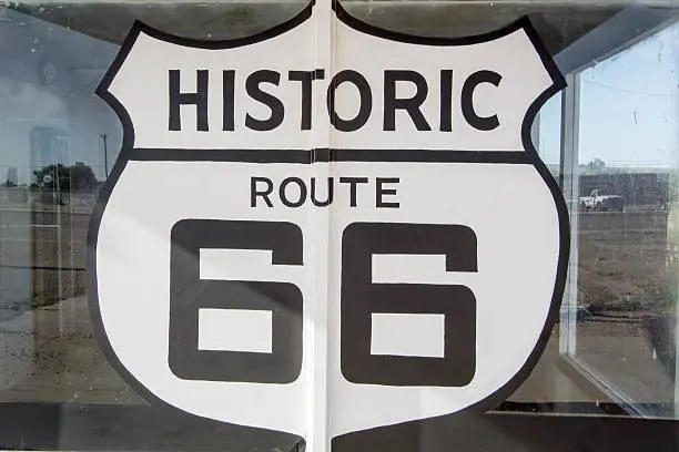 painted Route 66 sign on an old abandoned gas station window in Tucumcari, New Mexico