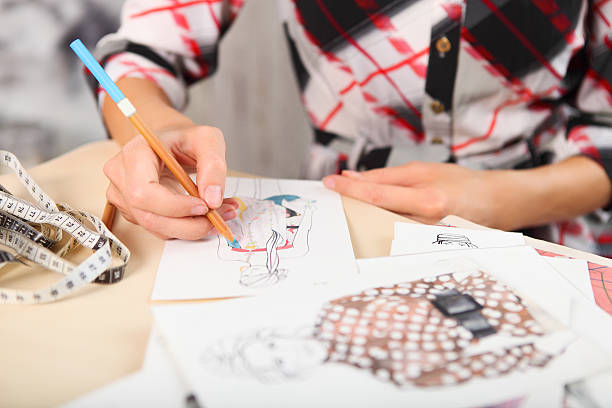 istock Dressmaker is drawing a fashion sketch 608488422