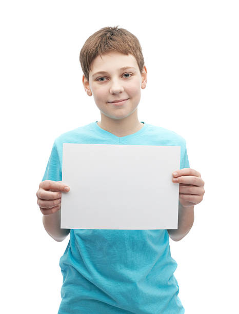 istock Happy smiling young boy with a sheet of paper 608492974