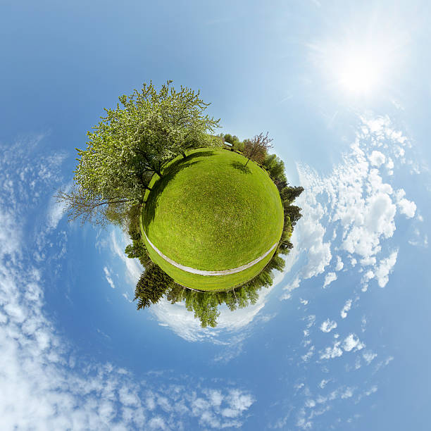 Little planet with trees and green meadow Little planet with trees, green meadow and blue sky 360 degree view photos stock pictures, royalty-free photos & images