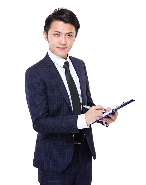 istock Businessman holding a clipboard and pen 608494640