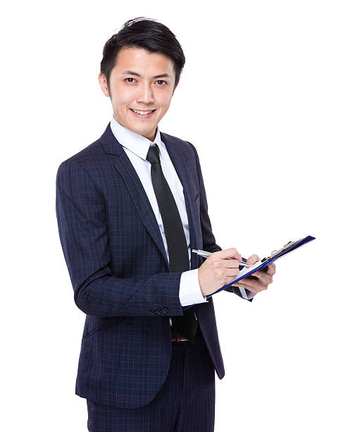 istock Businessman holding a clipboard and pen 608495924
