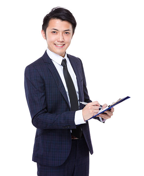 istock Businessman holding a clipboard and pen 608496140