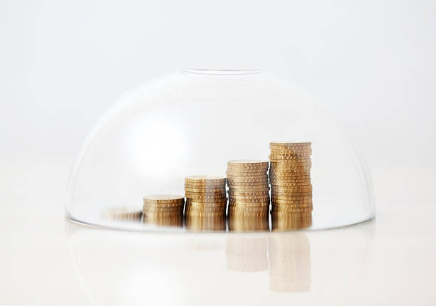 istock Rising golden coins protected under a glass dome 608498370