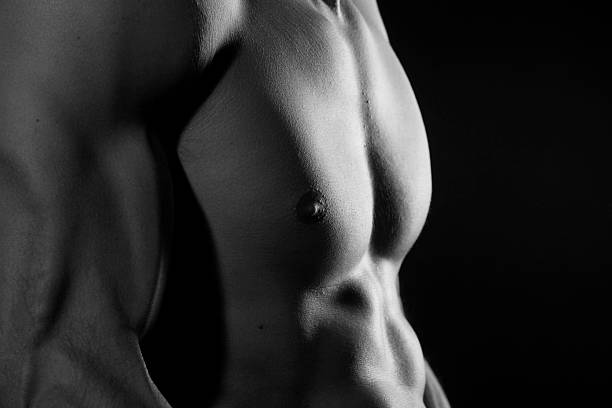 istock Muscular torso of young man black and white 608507946