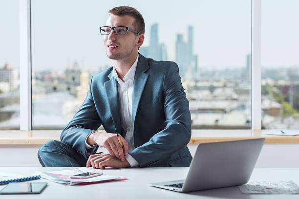 istock Smiling businessman in suit 608509712