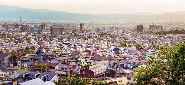 Large Panoramic aerial view of Aizu-Wakamatsu Japanese town at sunset on a Springtime day.