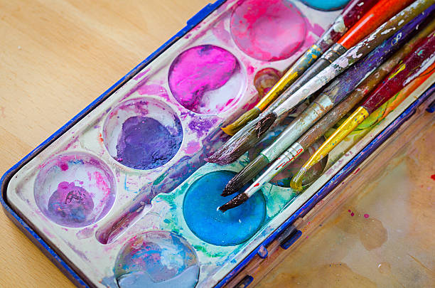 istock palette with watercolor ink and brush 608517468