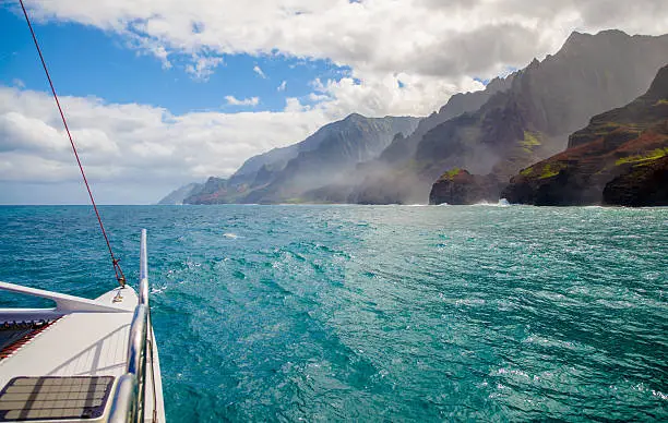 sailing along razor edged cliffs, rising more than 3000 feet high, on the remote and rugged napali coast of kauai, hawaii.