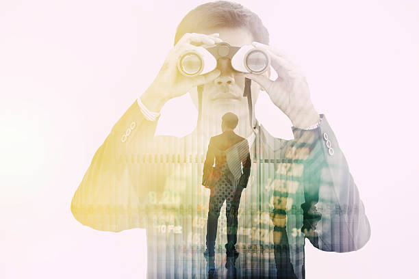 istock Double exposure businessman searching binoculars outdoors 608524782