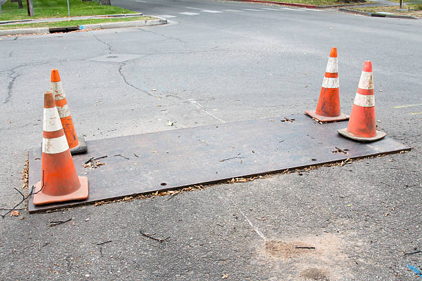 istock Metal plate covering a road construction hole 608525668
