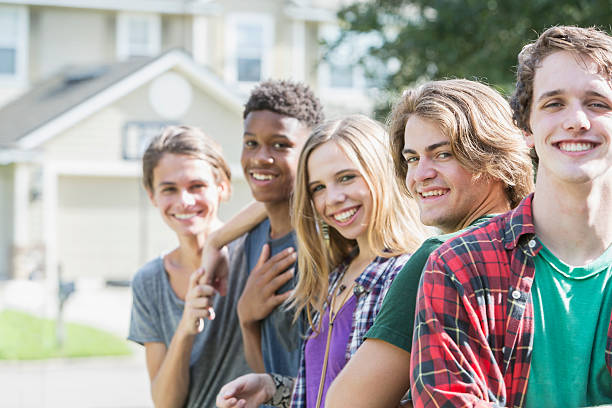 istock Group of five multi-ethnic teenagers hanging out 608526532