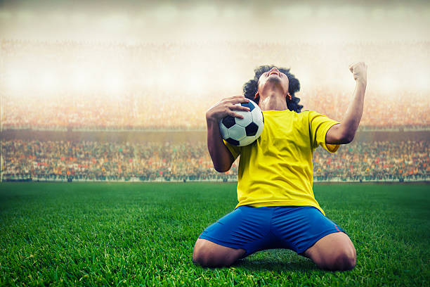 soccer or football player celebrating goal soccer or football player celebrating goal in the stadium during match sports activity stock pictures, royalty-free photos & images