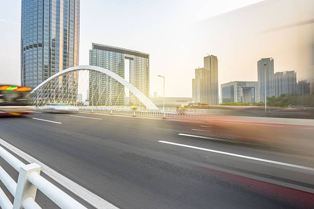 istock City road with moving car 608531090