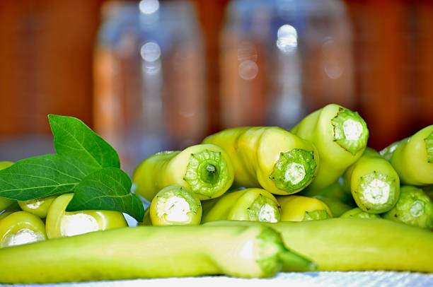 istock Yellow peppers and two jars in the background. 608537868