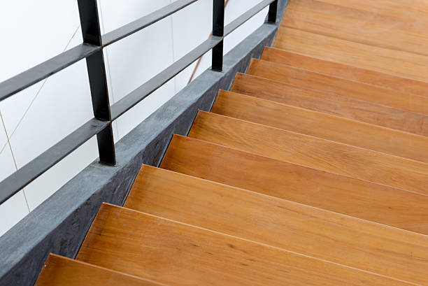 istock wooden staircase with iron banister 608538040