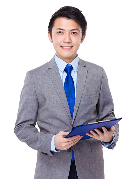 istock Businessman holding a clipboard 608539198