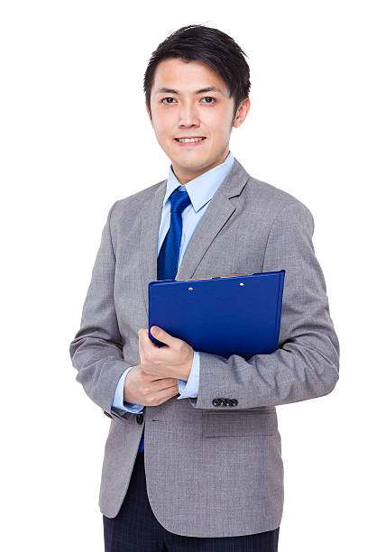 istock Businessman holding a clipboard 608539224