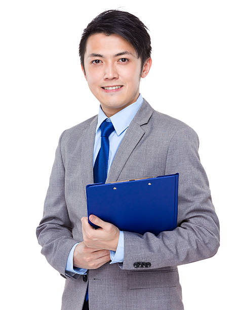 istock Businessman holding a clipboard 608539260