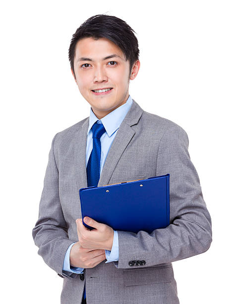 istock Businessman holding a clipboard 608539282