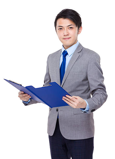 istock Businessman holding a clipboard 608539368