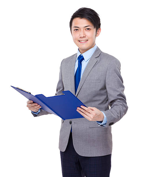 istock Businessman holding a clipboard 608539376