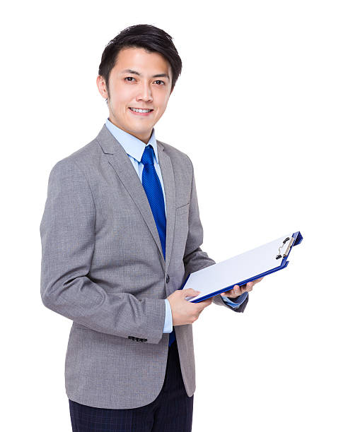istock Businessman holding a clipboard 608539404