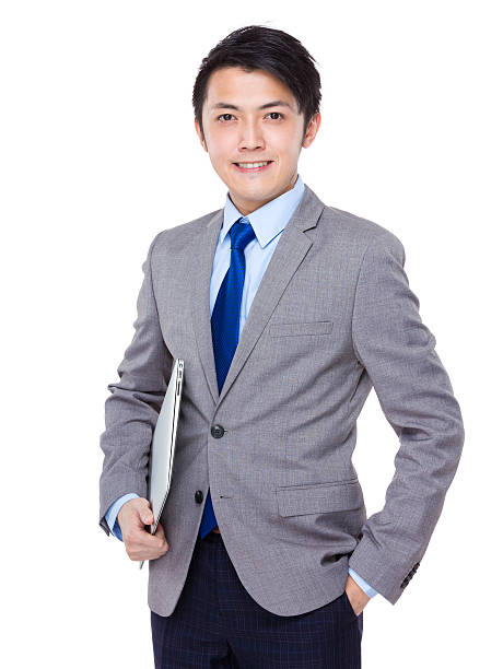 istock Businessman holding a laptop 608539522