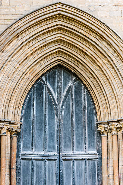 Peterborough Cathedral front wooden gate detail entrance outdoors stock photo
