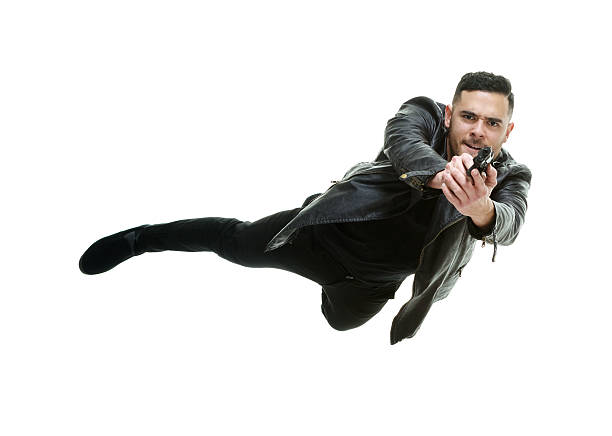 istock Male in jumping with handgun 608542618
