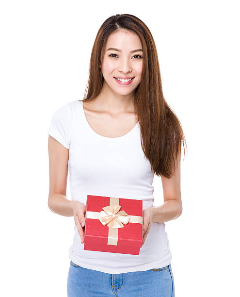 istock Woman holding a gift box 608546990