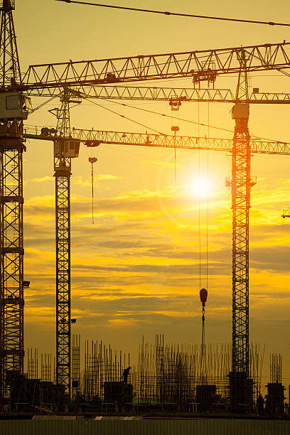 istock crane of building construction against beautiful dusky sky 608547340