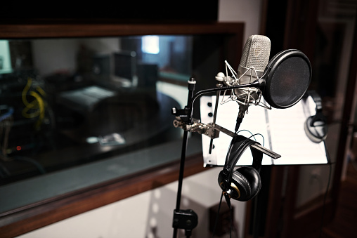 Modern microphone in recording studio, selective focus