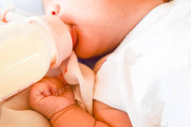 istock Newborn baby eating milk from the bottle. 608552886