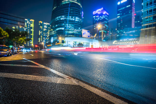 istock vehicle light trails at city road 608554094