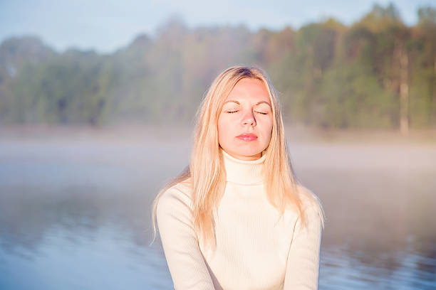 istock Young, gentle woman relaxing and enjoying a first sun rays. 608554166