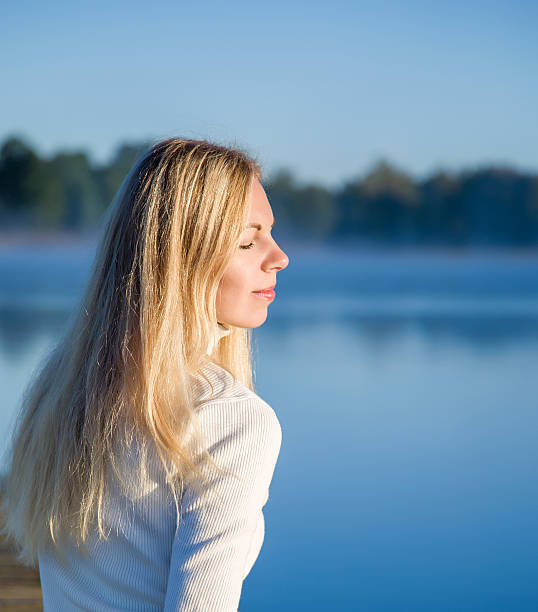 istock Young, gentle woman relaxing and enjoying a first sun rays. 608556294