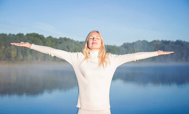 istock Woman relaxing and enjoying a first sun rays and freedom. 608557216